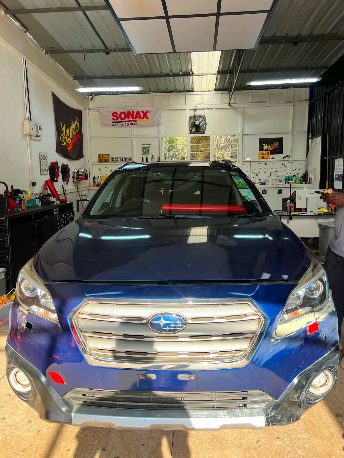 Subaru Outback before the satin red vehicle wrap